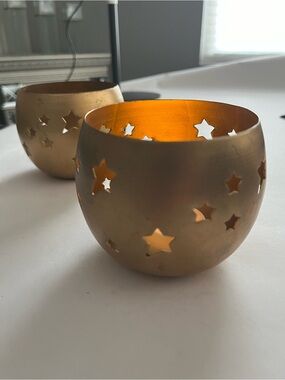 NWT two 4” brass colored candle holders decorated with stars.